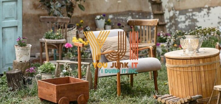 Vintage outdoor garden furniture and decor with wooden planters, chairs, and a barrel table, suitable for junk removal and disposal.