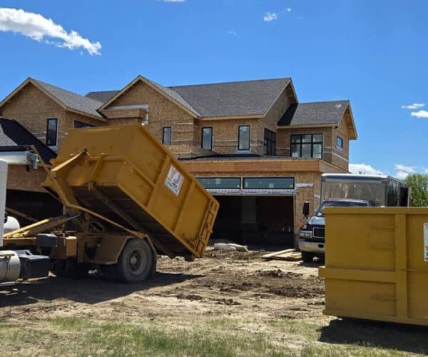 Todd dropping off a new YJI dumpster at a new home construction site