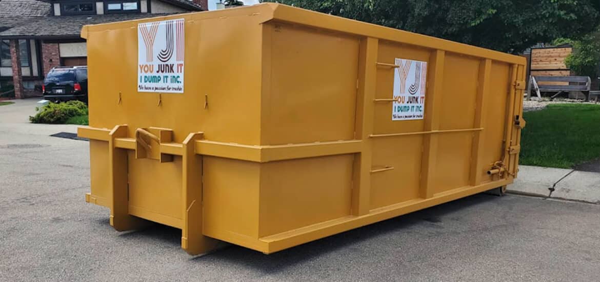 Large yellow dumpster for waste collection and junk removal services.