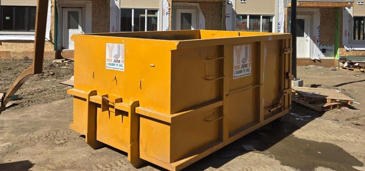 Heavy-duty construction dumpster for debris removal at building site.