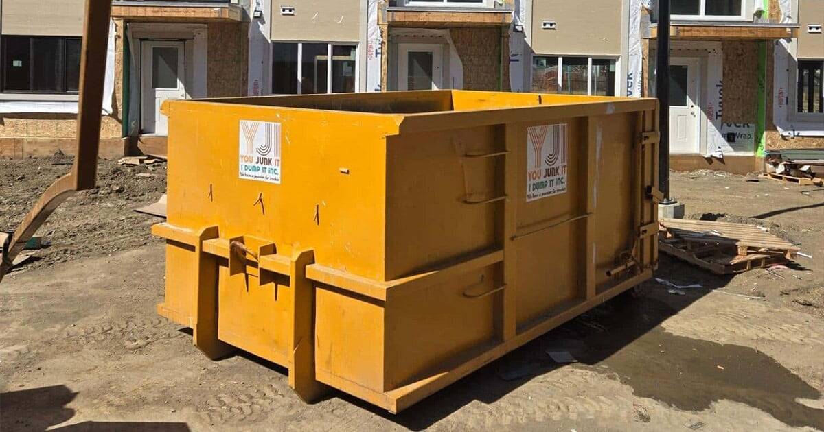 Heavy-duty construction dumpster for debris removal at building site.