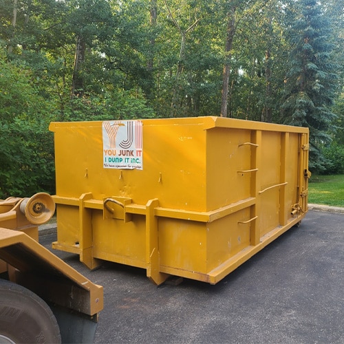 Yellow 12 yard bin being dropped off at a location