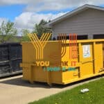 yellow junk bin sitting on the driveway of an edmonton home