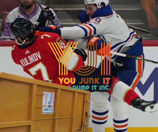 oilers player hitting florida player into a junk bin