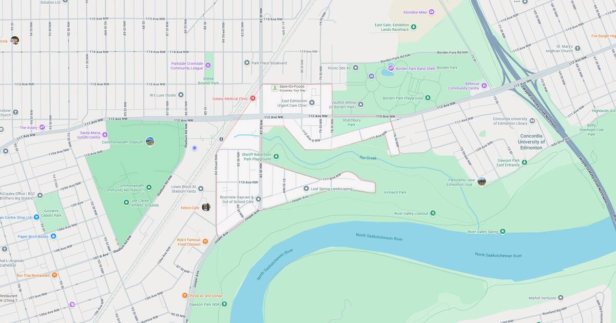 Map of a city park featuring green areas, walking paths, and a river running through the landscape.