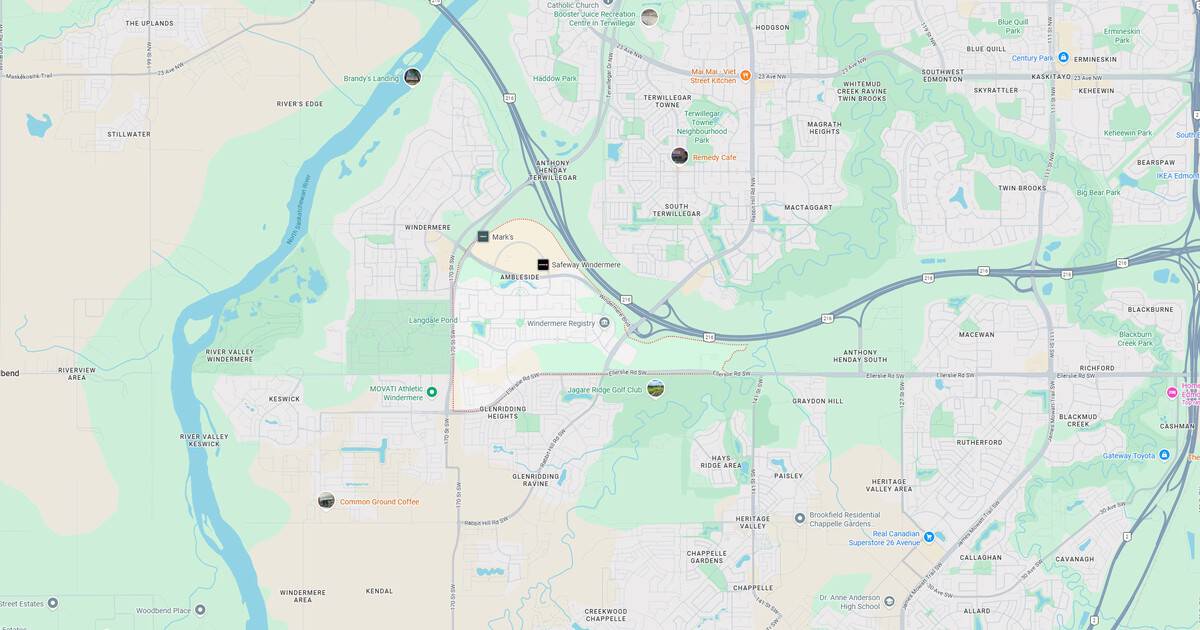 Map of riverfront park, walking trails, and surrounding urban area with roads and natural features.
