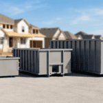 Waste disposal containers for construction debris on a paved surface in a suburban area.