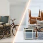 Bicycle parked next to stacks of papers, a vintage computer monitor, and cardboard boxes, indicating a workspace or moving setup.